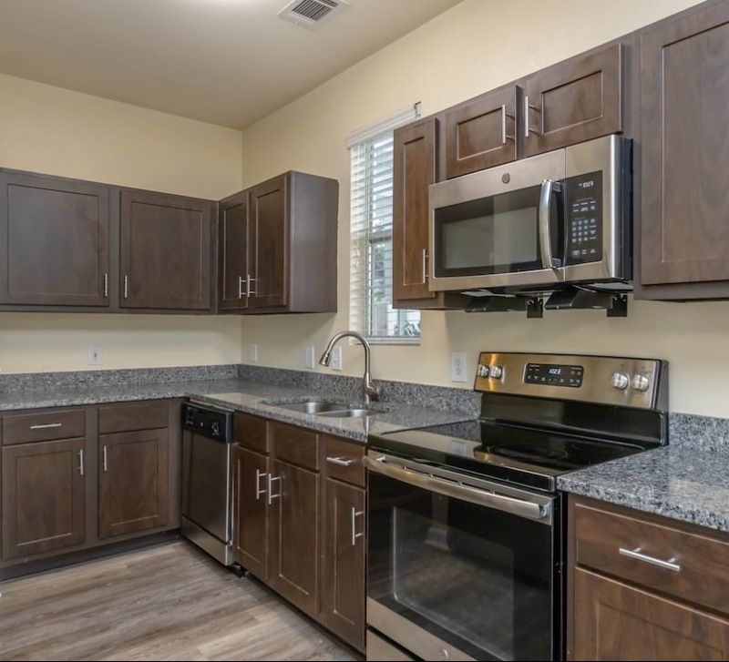 Large well lit kitchen with wood floors 